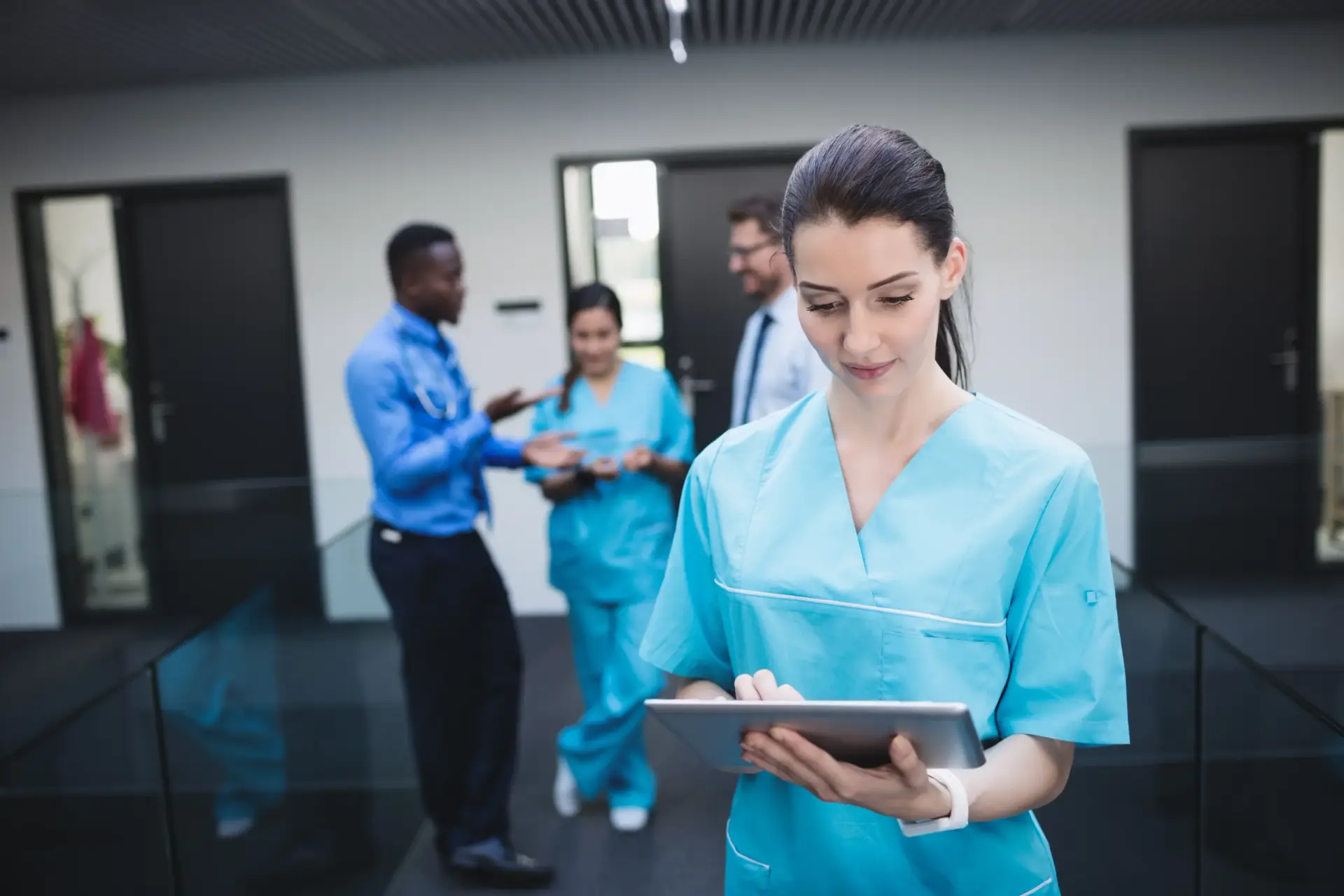 Nurse using a hospital management system on a digital tablet